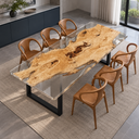 Elevated side view of a poplar dining table with pale golden wood encased in clear epoxy resin and brown dining chairs.