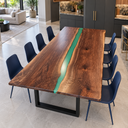 Angled view of a black walnut dining table with a slender emerald green epoxy resin stream