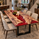 Walnut and ruby red epoxy resin dining table styled with a fruit bowl, vase and candles