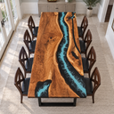 Overhead view of a walnut dining table with a blue current flowing through black epoxy resin