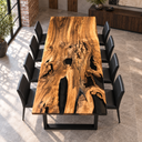 Elevated end view of a walnut dining table with branching grain and black epoxy resin details