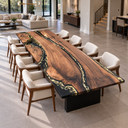 Elevated corner view of a black walnut dining table showing flowing grain and gold-toned details in the black epoxy resin.