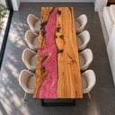Overhead lengthwise view of an olive wood and rose pink epoxy resin dining table