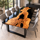 Angled view of an olive wood dining table with a golden wood island surrounded by glossy black epoxy resin