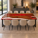 Wide side view of a walnut and red and white epoxy resin dining table with cream chairs