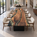 Front view of a rectangular black walnut dining table with black epoxy resin and gold-toned patterns in an open-plan dining room.