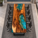 High end view of a walnut epoxy resin conference table with two blue-green coastal inlays and black office chairs