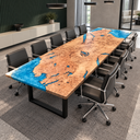 Angled view of a poplar epoxy resin conference table beside a dark green paneled wall and cream cabinet