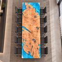 Overhead end view of a poplar epoxy resin conference tabletop showing blue resin-filled openings and patterned wood