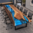 Angled view of a walnut epoxy resin conference table with a translucent blue river and contrasting wood sections