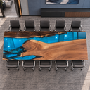 Landscape overhead view of the walnut epoxy resin conference table with a blue river and sweeping wood grain