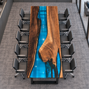 Top-down lengthwise view showing the walnut conference table's asymmetrical wood contours and blue epoxy resin